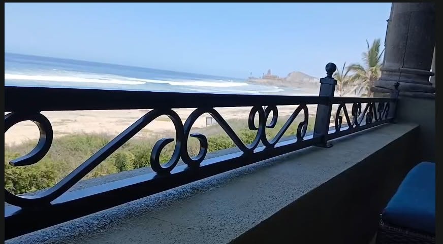 Wrought iron balcony railing overlooking the beach