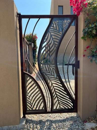 Decorative metal gate with palm leaf pattern
